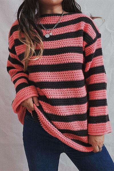 a woman wearing a pink and black striped sweater