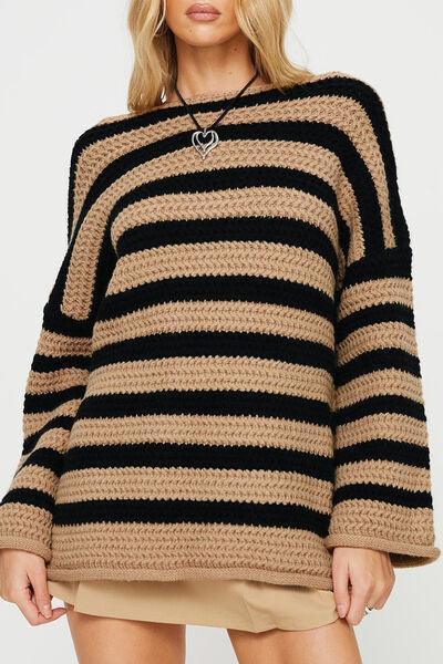 a woman wearing a black and tan striped sweater