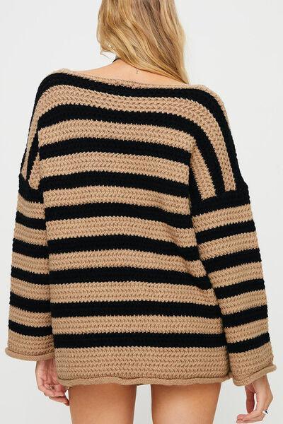 a woman wearing a black and tan striped sweater