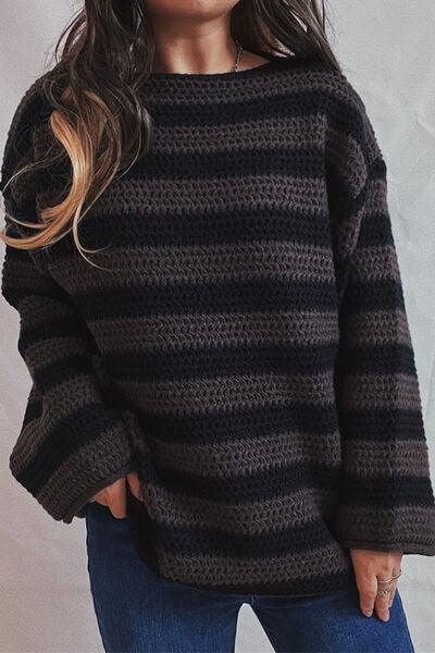 a woman wearing a black and grey striped sweater