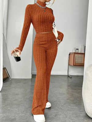 a woman in an orange sweater and matching pants