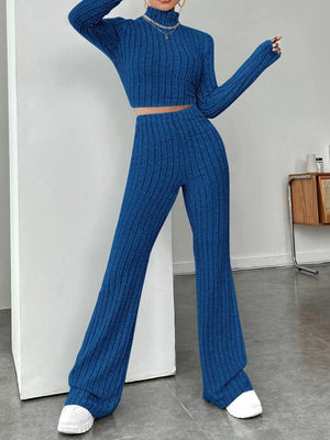 a woman in a blue sweater and matching pants