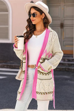 a woman wearing a white hat and a pink cardigan