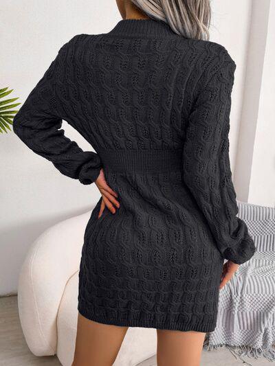 a woman wearing a black cable knit sweater dress