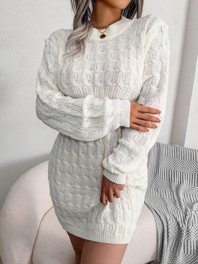 a woman posing in a white sweater dress