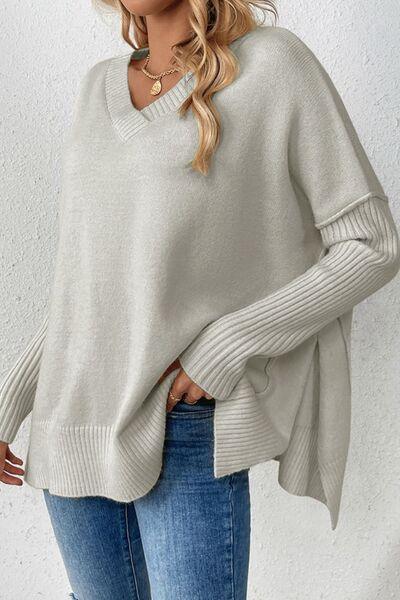 a woman wearing a white sweater and jeans