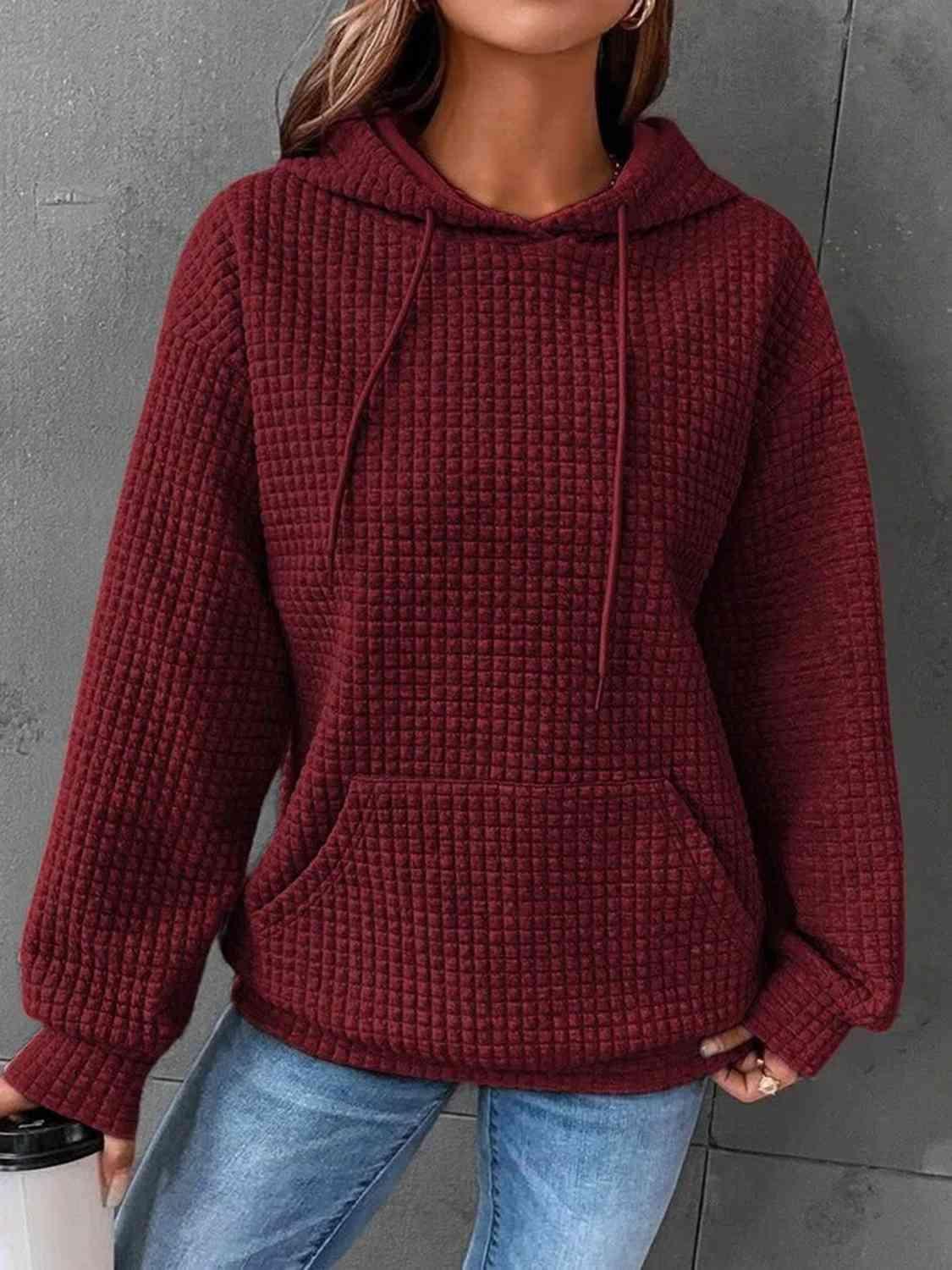 a woman wearing a red sweater and jeans