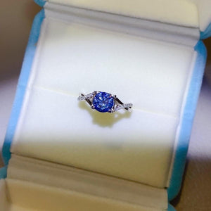a blue and white diamond ring in a box