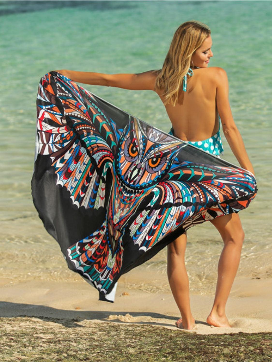 a woman is walking on the beach with a dress