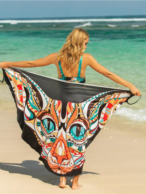 a woman in a bathing suit holding a cat print scarf