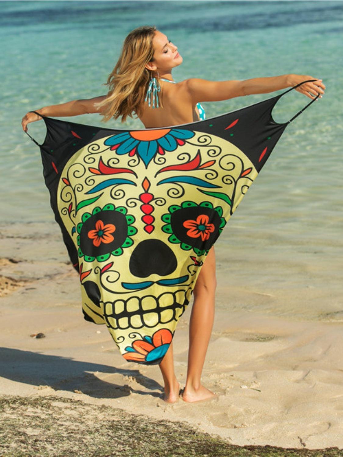 a woman in a bikini holding a skull shaped towel