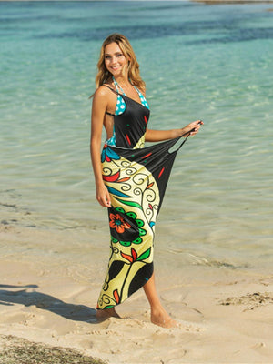 a beautiful woman standing on top of a sandy beach