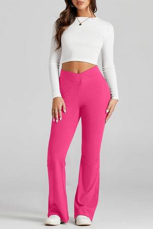 a woman in a white top and pink pants