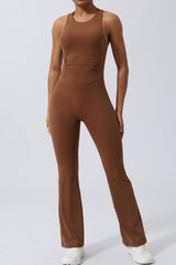 a woman in a brown jumpsuit posing for a picture