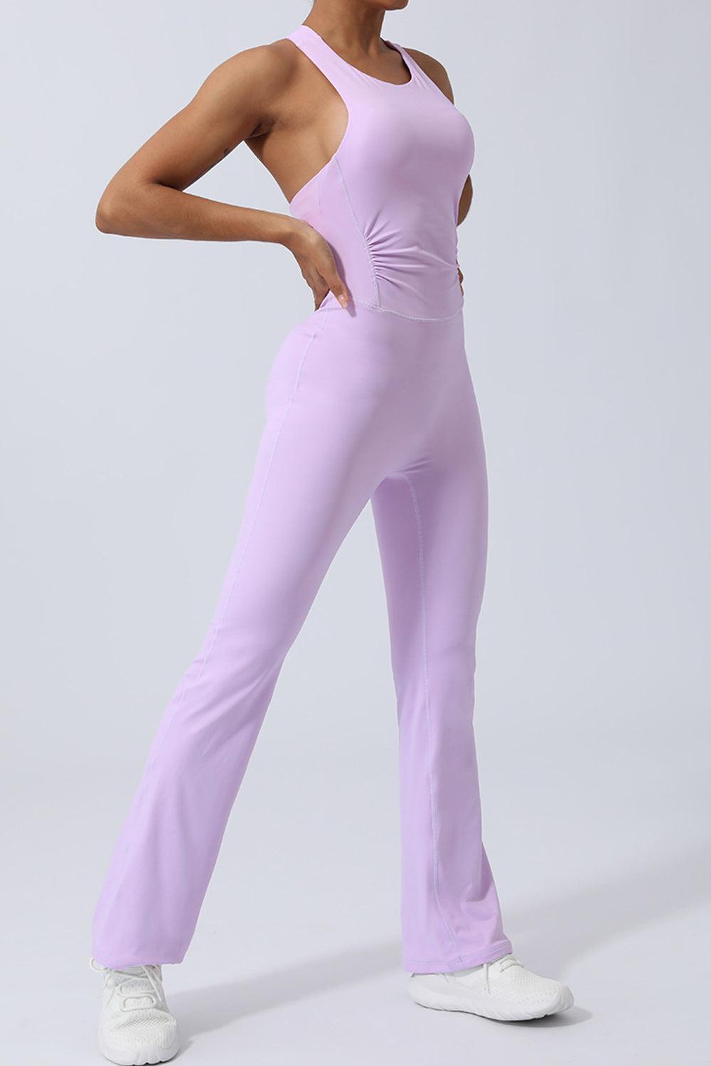 a woman in a purple jumpsuit posing for a picture