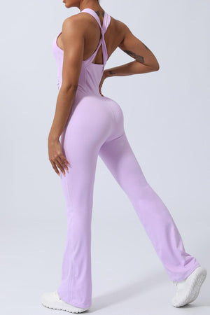 a woman in a purple jumpsuit and white sneakers