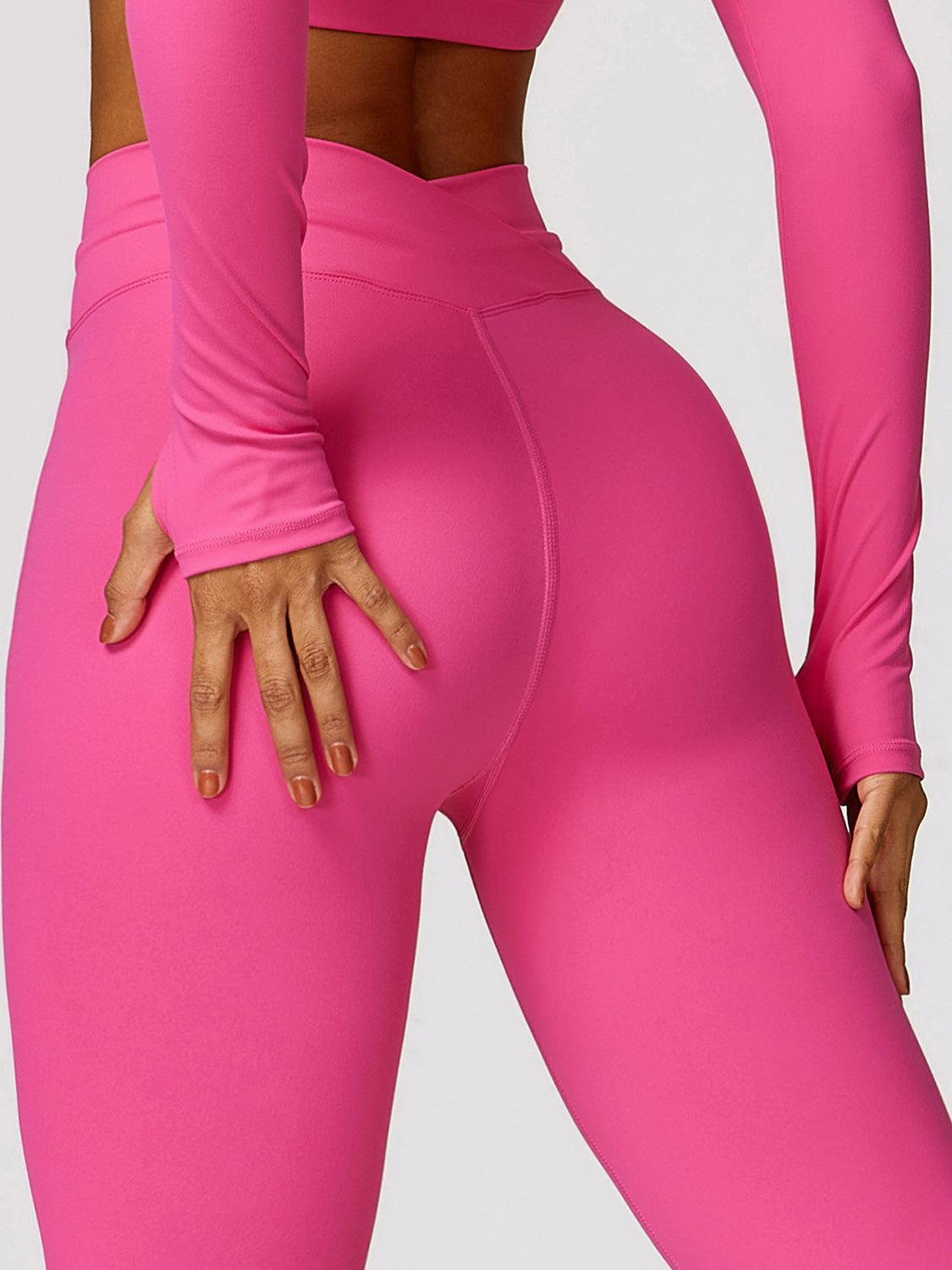 a woman in a pink sports suit with her hands on her hips