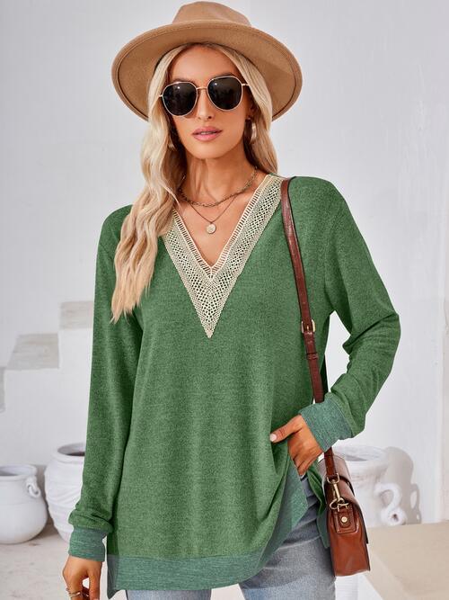 a woman wearing a green sweater and hat