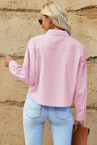 a woman wearing a pink shirt and jeans