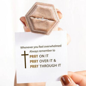 a person holding a card with a ring on it