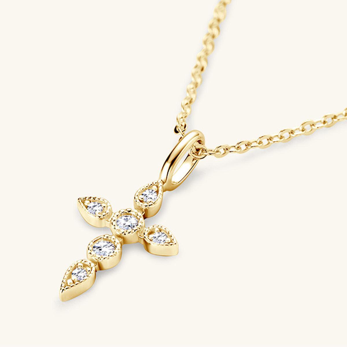 a diamond cross pendant on a gold chain