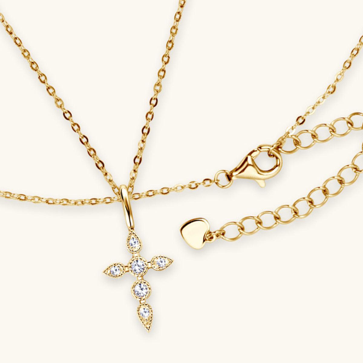 a gold necklace with a cross on it