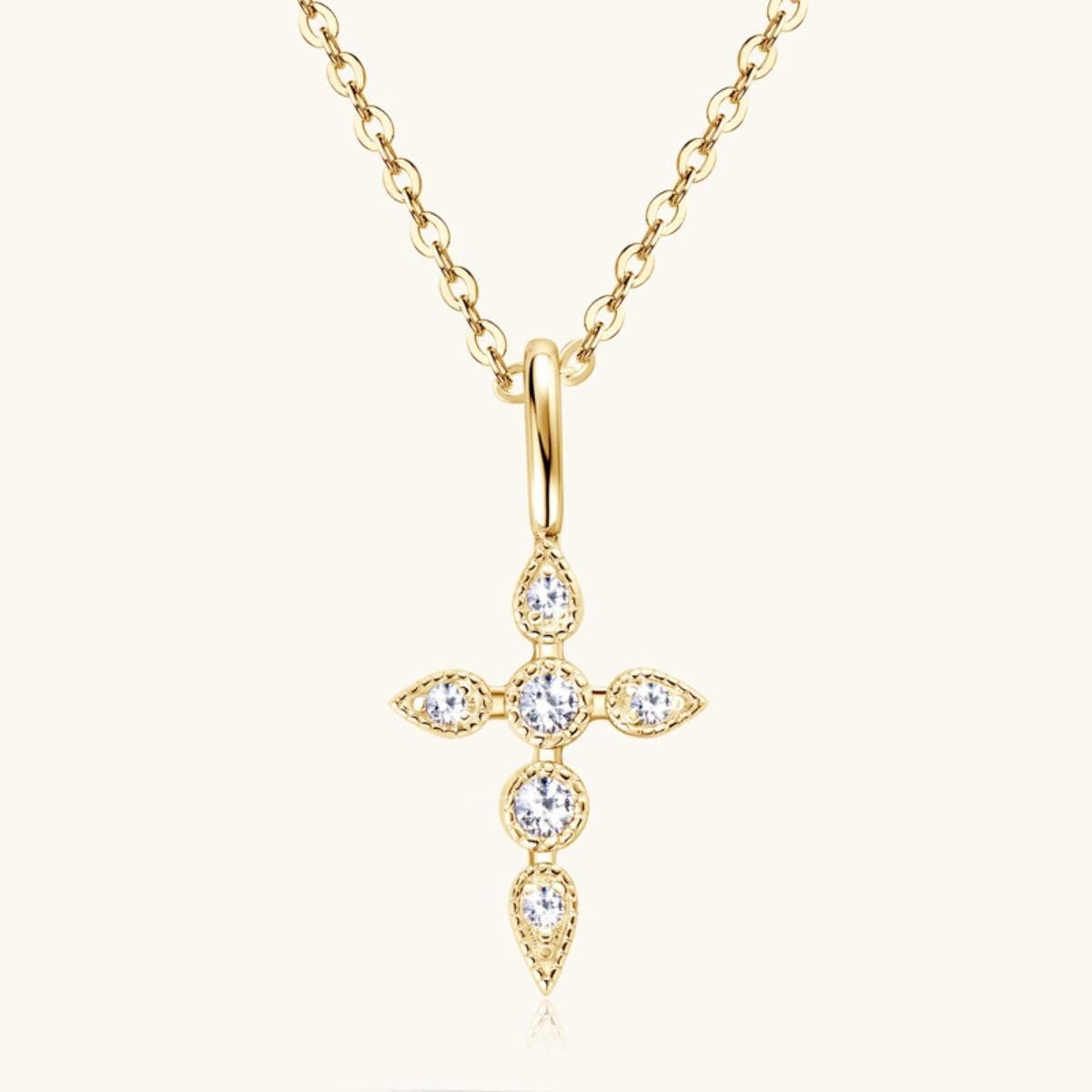 a gold cross necklace with diamonds on a chain