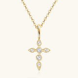 a gold cross necklace with diamonds on a chain