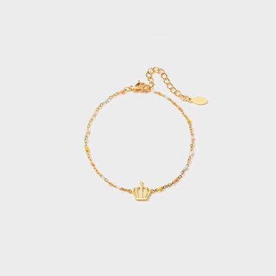 a gold bracelet with a crown charm