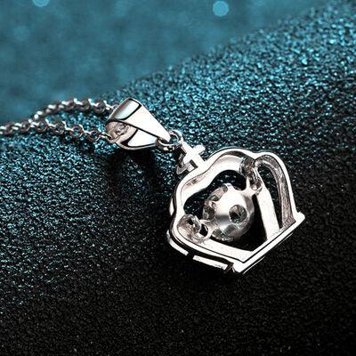 a silver necklace with a heart shaped object on it