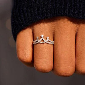 a close up of a person's hand with a ring on it