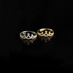 two gold rings with diamonds on a black background