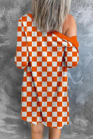 a woman wearing an orange and white checkered dress