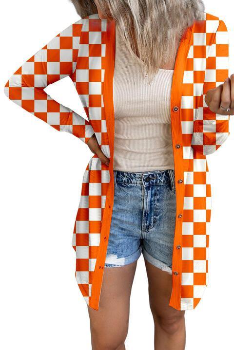 a woman wearing an orange and white checkered cardigan