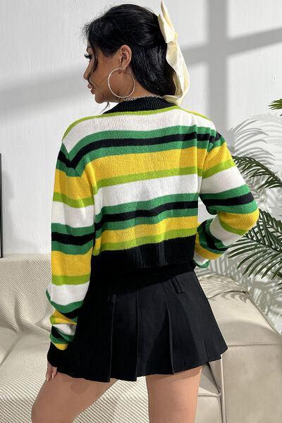 a woman wearing a colorful striped sweater and black pleated skirt