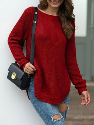 a woman wearing a red sweater and ripped jeans