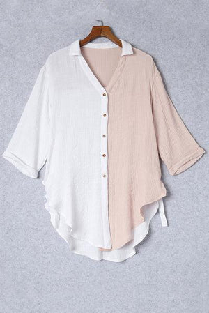 a white and pink shirt hanging on a hanger