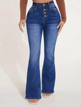 a woman in a brown top and blue jeans