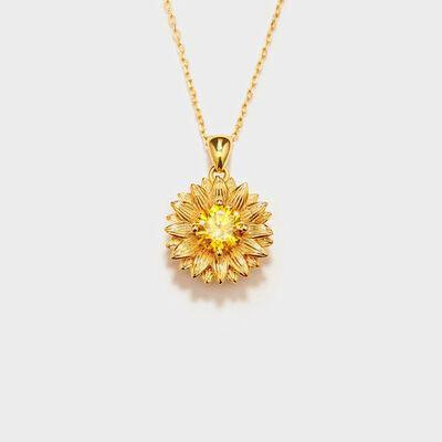 a yellow necklace with a flower design on it