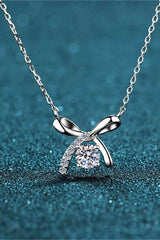 a diamond necklace with a bow on it