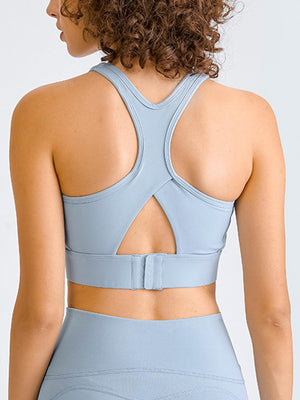 the back of a woman wearing a light blue sports bra