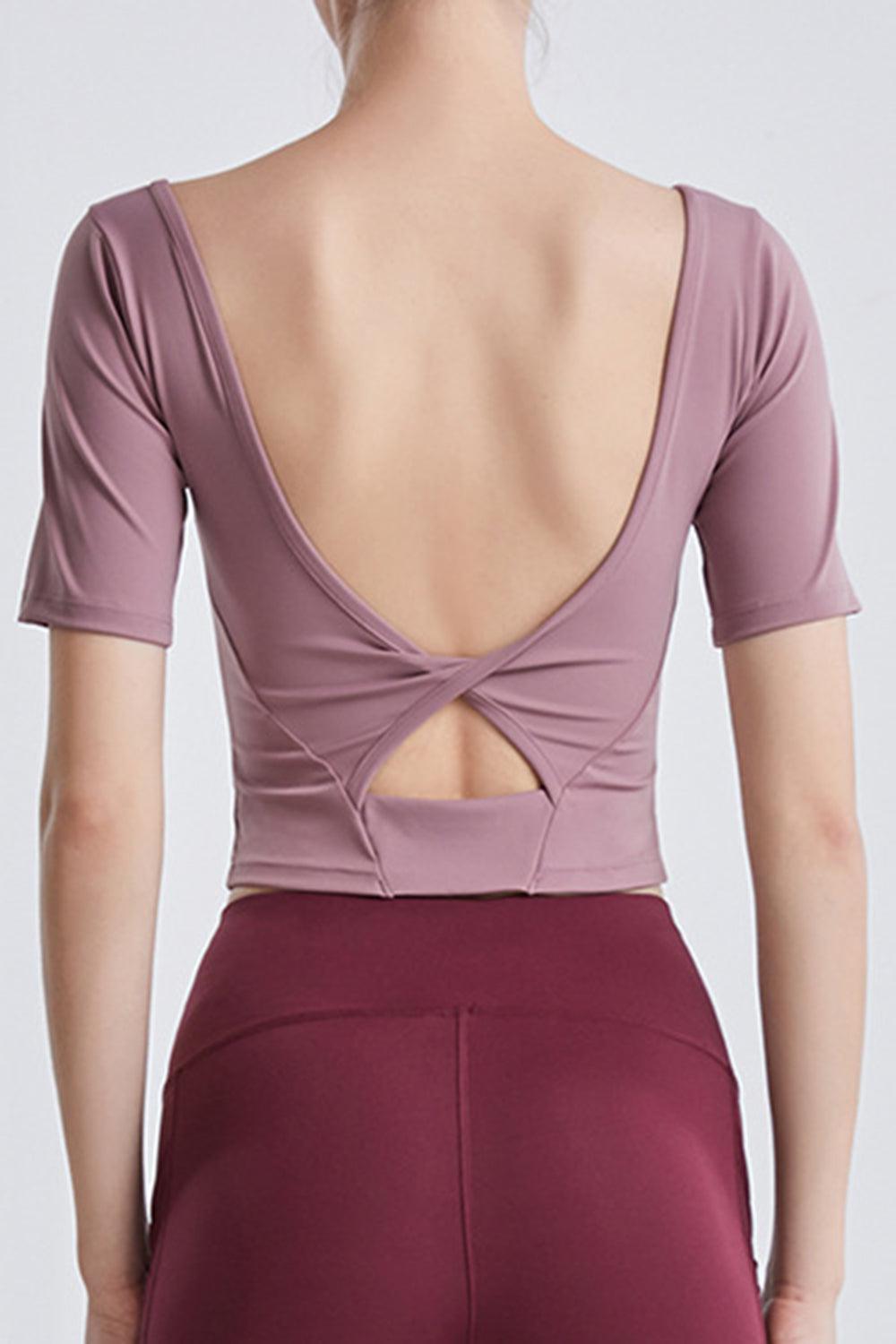 the back of a woman wearing a purple top