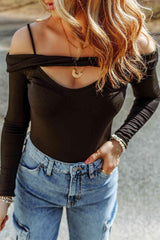 a woman wearing jeans and a black top