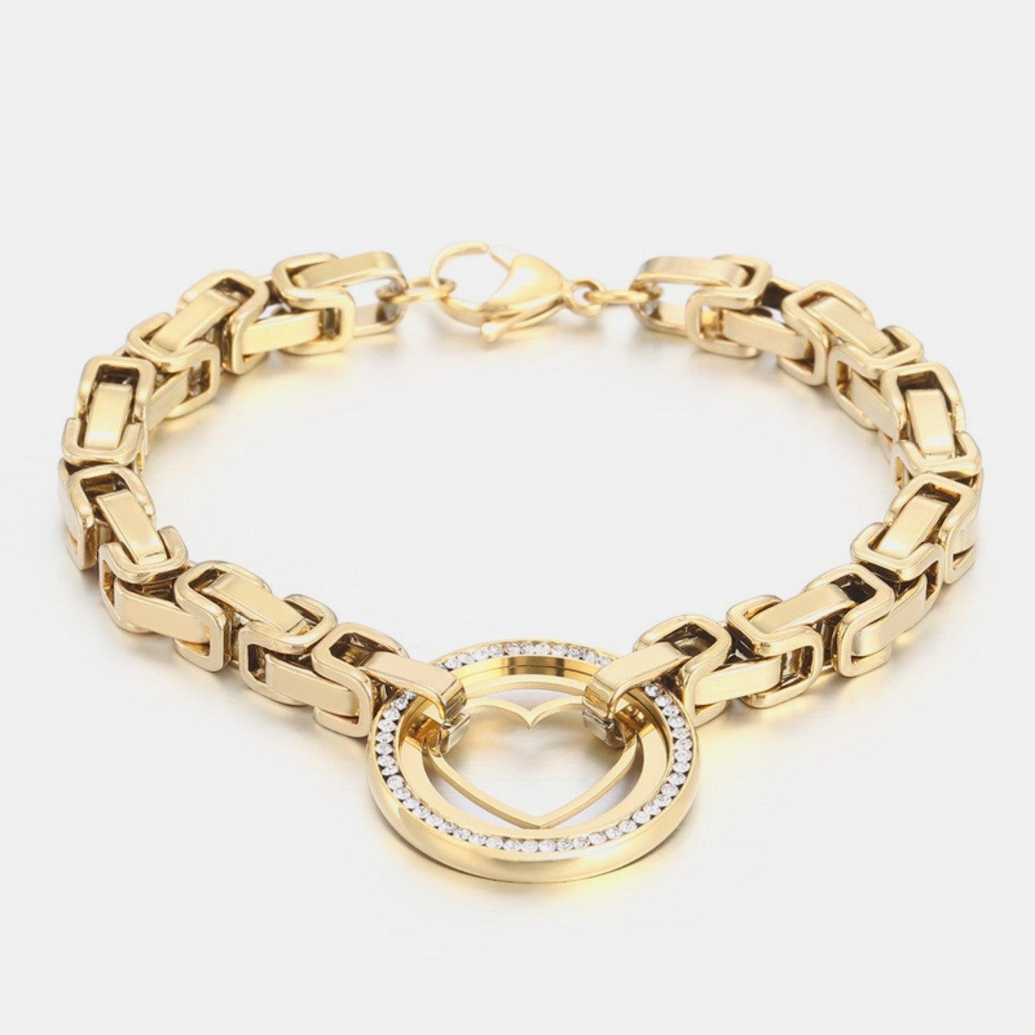 a gold bracelet with a heart charm