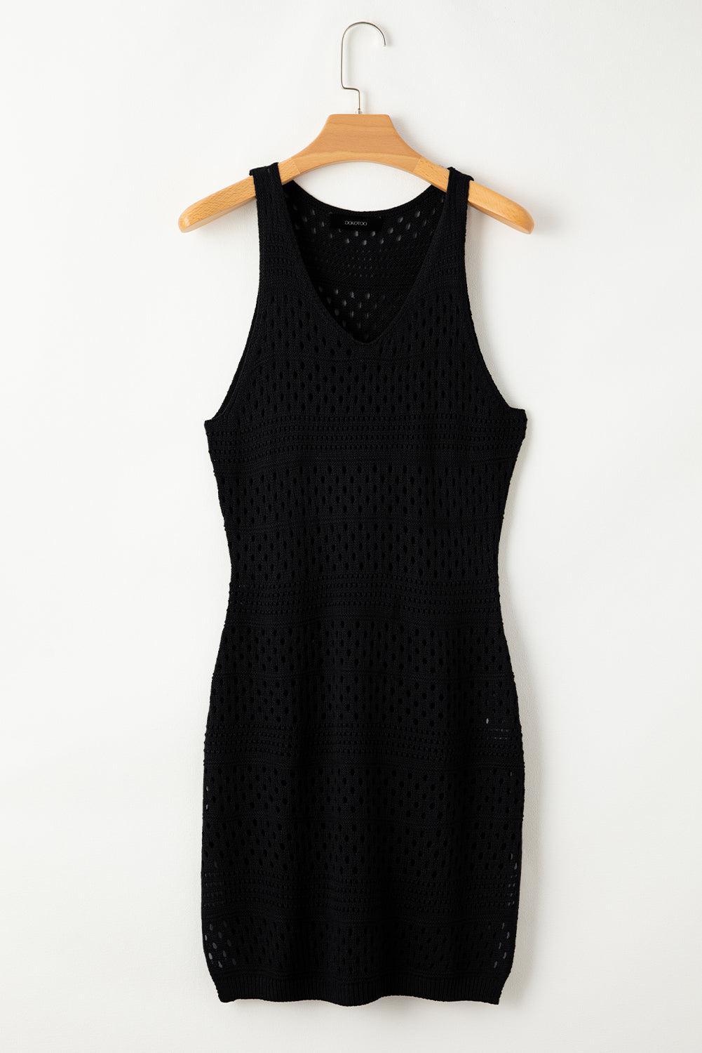 a black dress hanging on a wooden hanger