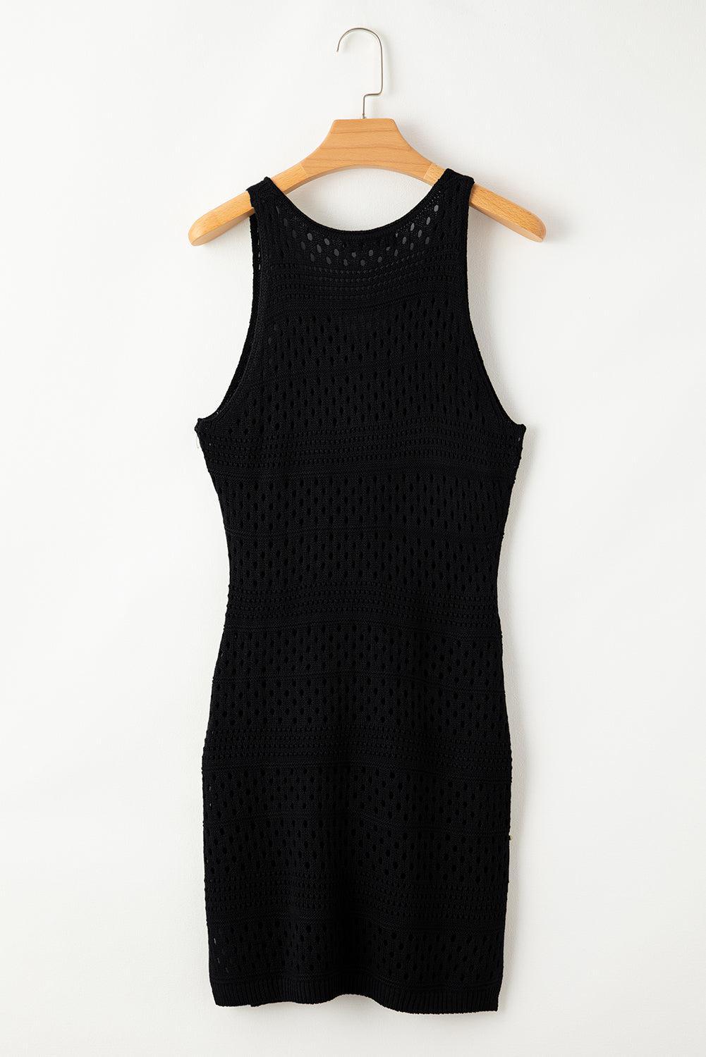 a black dress hanging on a wooden hanger