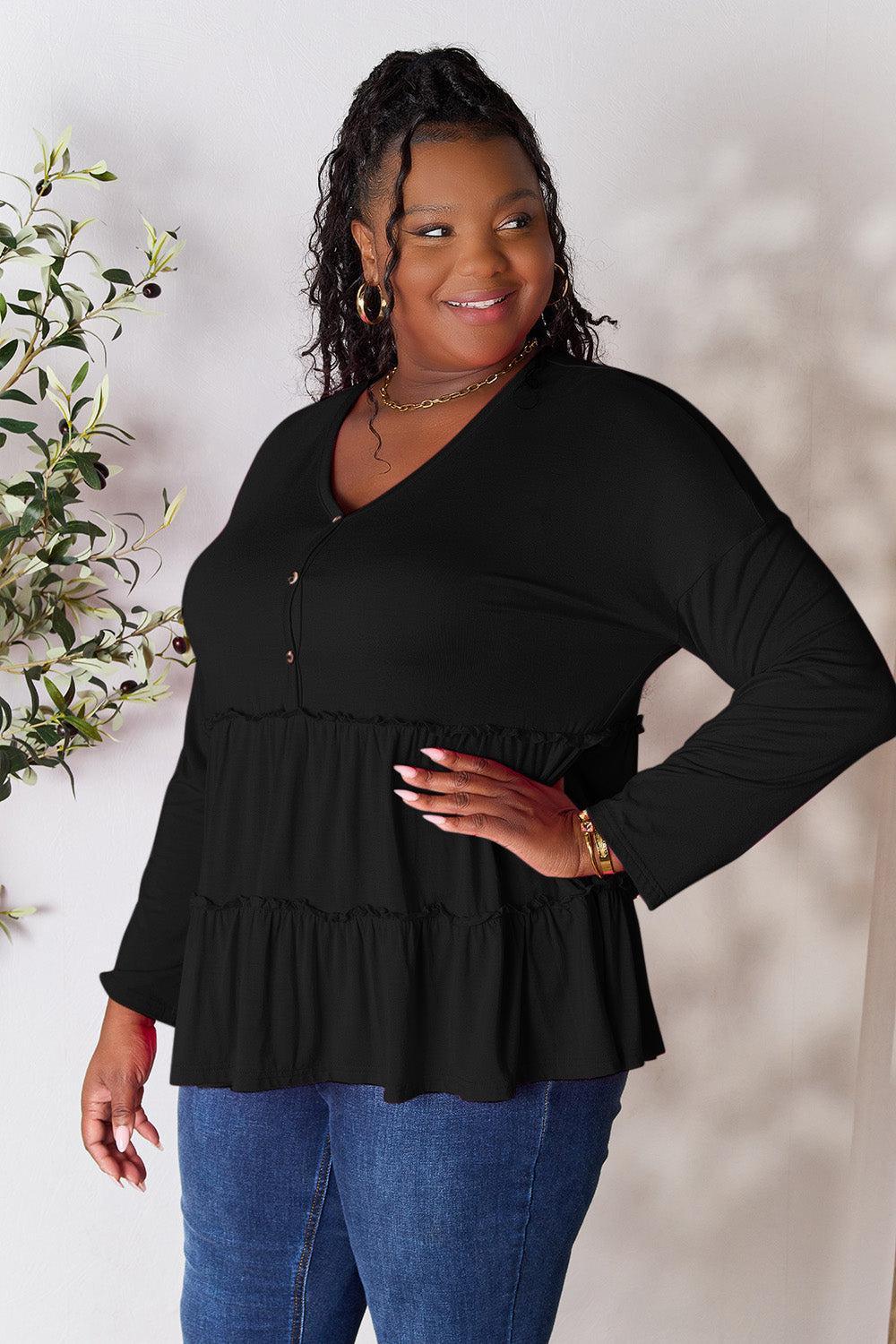 a woman standing in front of a white wall