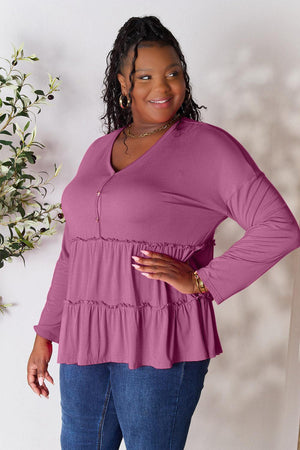 a woman standing in front of a white wall