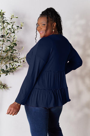 a woman standing in front of a white wall