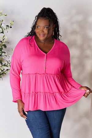 a woman in a pink top posing for a picture